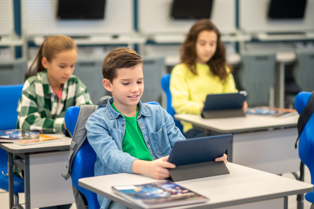 This is an image of students working on tablets at their desks. 